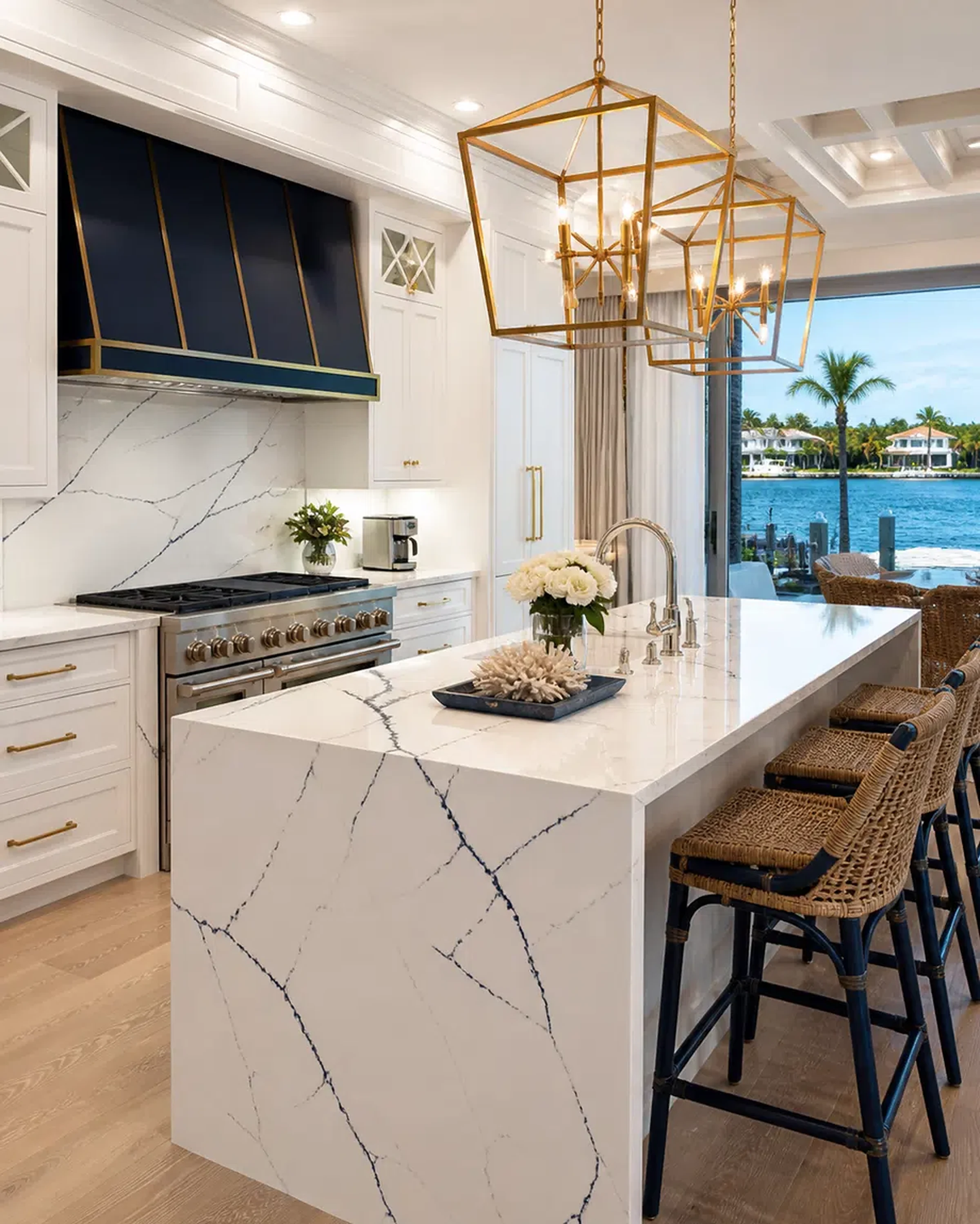 Luxury Lake Worth kitchen with cabinet storage, quartzite-style island, and brass accents