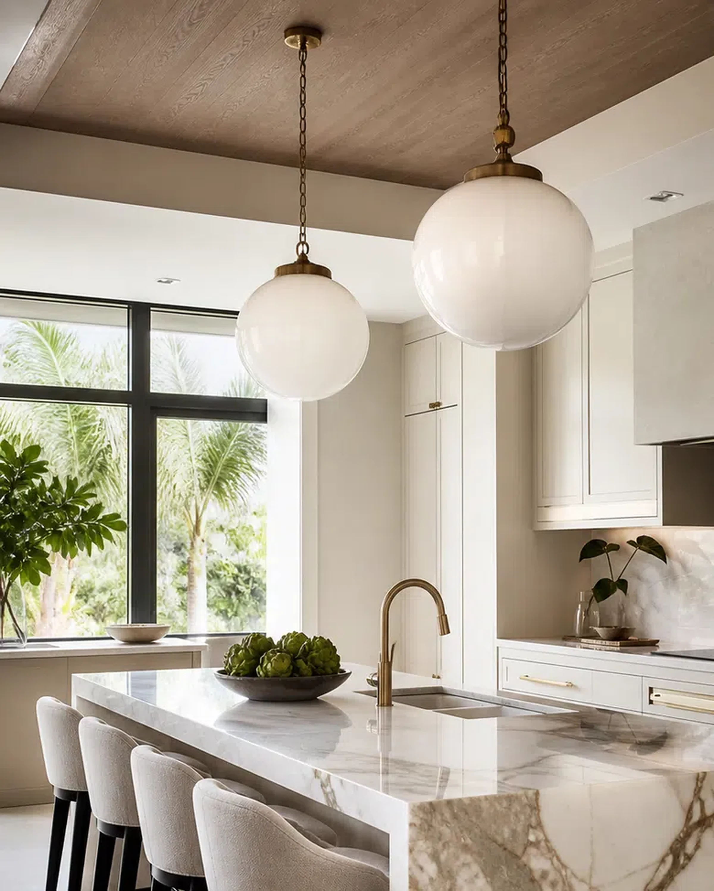 Bright Loxahatchee kitchen remodel with large island, cabinet storage, and stone surfaces