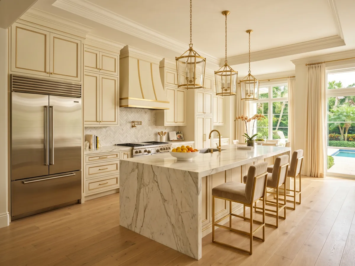 Luxury Palm Beach Gardens country club kitchen with cream and gold inset cabinets and thick mitered calacatta marble countertop